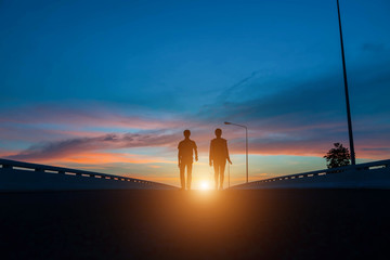 Fototapeta premium silhouette couples Jumping at sunset