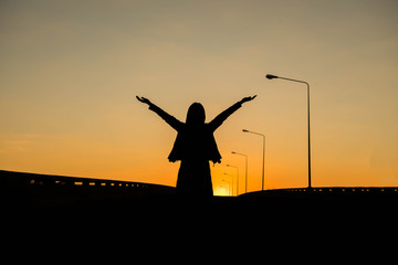 Silhouette of a woman with evening sky.