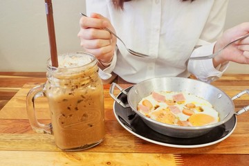 Breakfast Meal Consisting of Iced Coffee and Fried Eggs