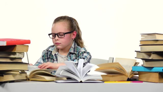 Girl carefully read and write data to the notebook. White background