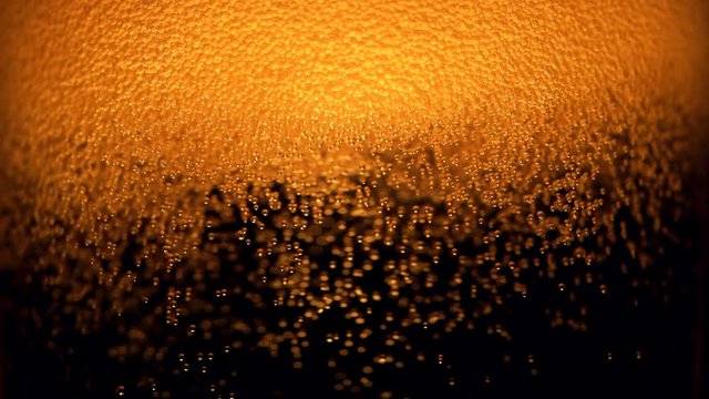 Extreme close-up beer in glass. Shot with high speed camera, phantom flex 4K. Slow Motion.