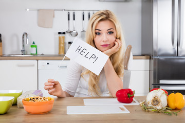 Woman Holding Help Flag In Kitchen