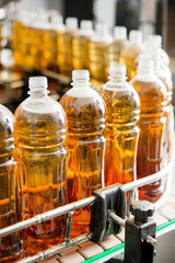 Obraz na płótnie Canvas Filling bottles with juice
