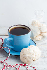 cup of coffee and meringue on a white background