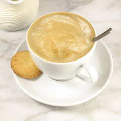 Coffee with milk, butter cookie and milk jar