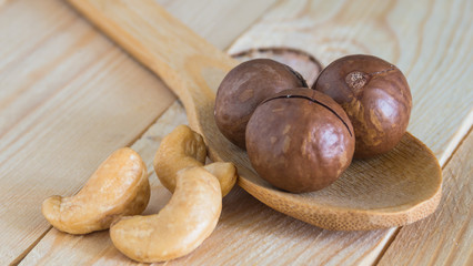 cashew nut and macadamia on wooden table