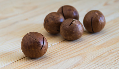 Macadamia nuts on wooden table