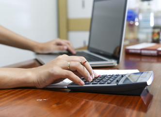 woman working with calculator, business document and laptop computer notebook,business  finance, selective focus