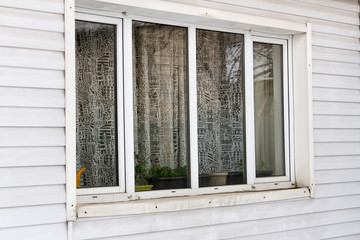 large plastic window on the wall of siding