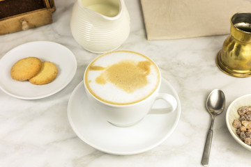 Coffee with milk, butter cookie and milk jar