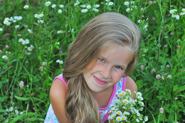 Portrait of a little girl on a green background. © alena0509