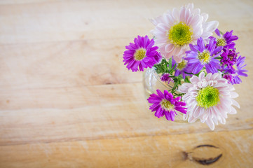 Pink and white flowers on  wooden background. Flat lay. Top view with copy space. Selective focus.