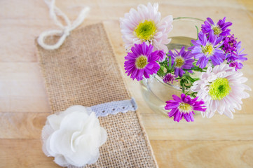 Pink and white flowers on  wooden background. Flat lay. Top view with copy space. Selective focus.