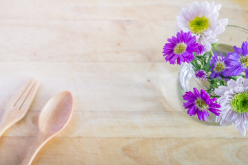 Pink and white flowers on  wooden background. Flat lay. Top view with copy space. Selective focus.