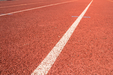 Red running track close up background.