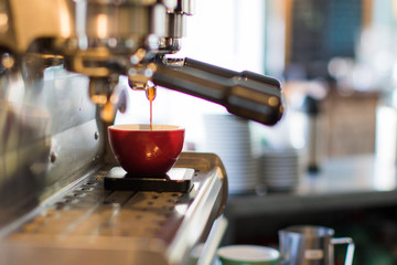 Espresso shot being poured into cup