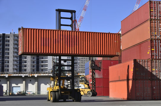 Toplifter handling cargo container loading to container trailer in import export logistic zone

