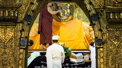 Mahamuni Buddha or Payagyi face wash every morning by monks at Mandalay, Myanmar