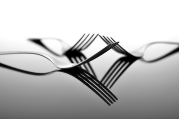 Forks on glossy table surface
