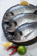 Close-up of raw dorados with seasonings, selective focus
