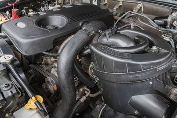 Car maintenance service, air filter closeup in car cabin beneath bonnet.