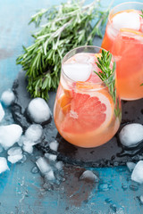 Grapefruit and rosemary gin cocktail, refreshing drink with ice