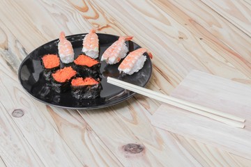 Sushi Close up in black plate on wooden background, Asian food delicious