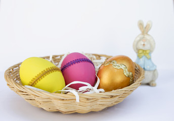 Colorful Easter egg design and blurred Easter bunny on white background