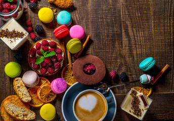 lot of different sweets spilling on wooden table