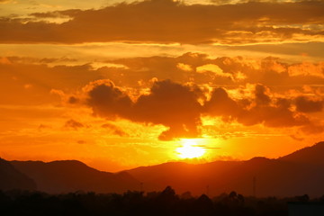 Sunset in sky and cloud,  beautiful colorful  twilight  time with mountain silhouette