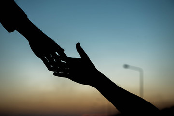 silhouette of helping hand concept