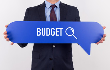 Businessman holding speech bubble with a word BUDGET