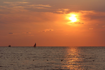 Pacific Ocean orange sunset on the beach in koh mak thailand