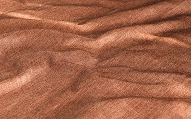 Copper-red creased material background or texture.