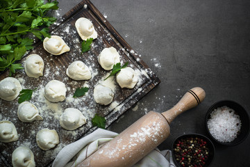 Traditional pelmeni or dumpling at cutting board.