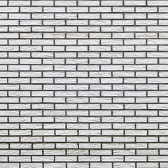 square part of light colored brick wall