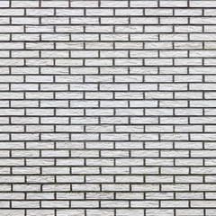 square part of light colored brick wall