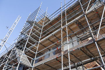 scaffolding under blue sky on new housing facility in the netherlands