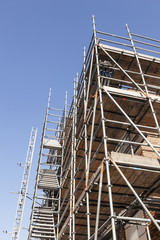 scaffolding under blue sky on new housing facility in the netherlands