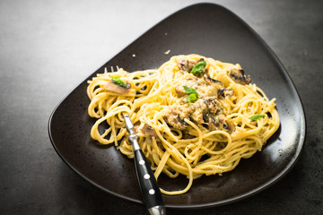 Pasta with mushrooms and white sause with basil.