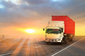Generic big trucks speeding on the highway at sunset - Transport industry concept , big truck...