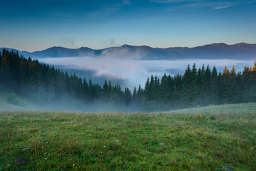 Dawn, shrouded in fog in mountains