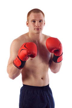 Full length portrait of young male boxer flexing muscles isolated over white background