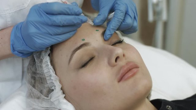 Cosmetic injections in forehead of young patient