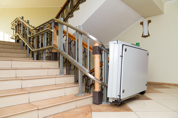 Stair lift for the disabled. Stairs of public building.