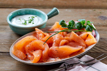 Gourmet platter of fresh smoked salmon with herbs