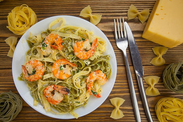delicious fettuccine pasta with prawns on white plate