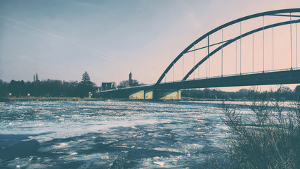 Bridge over a frozen river landscape view matte look
