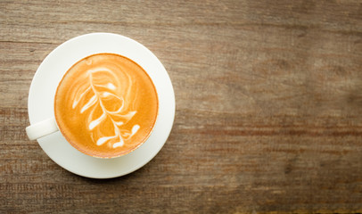 Coffee cup top view on old wooden