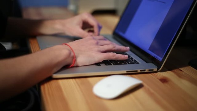 Businessman hands typing on a laptop keyboard,  working with NoteBook in the desk office -Dan